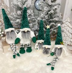 three gnomes are standing next to each other in front of christmas trees and decorations