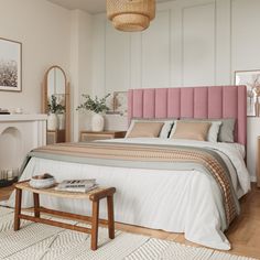 a bedroom with a pink headboard and white walls