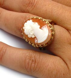 "10k Yellow Gold Cameo Ring Size 6.5 Cameo measures approx. 3/4\" X 1/2\" or 2 cm X 1.6 cm Cameo has a crazing in the stone (small hairline result of aging and dehydration) - this price is reduced Ring cameo rise (from finger, when worn) approx. 1 cm high or 3/8\" Total Weight of the ring: 6.6 Grams 041315-4047 FEEL FREE TO MESSAGE ME WITH A BEST OFFER OR IF YOU WISH TO SEE MORE PICTURES! We combine shipping where you pay only $1.00 more for any additional items on the same order! * Back to Shop White Cameo Rings For Wedding, White Cameo Wedding Rings, Formal White Cameo Rings, White Cameo Collectible Rings, Collectible White Cameo Rings, Shell Ring, Cameo Ring, Dehydration, Woman Face