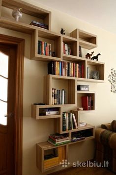 the bookshelf is made out of wood and has many different types of books on it