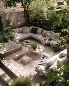 an outdoor living area with couches, tables and plants in the middle of it