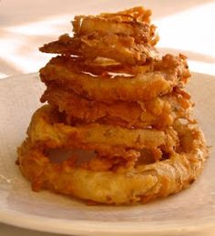 a stack of fried food sitting on top of a white plate