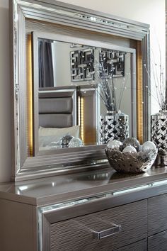 a large mirror sitting on top of a dresser