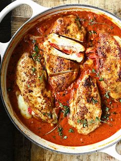 a pan filled with meat covered in sauce and garnished with parmesan