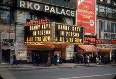 an old photo of people standing in front of a theater