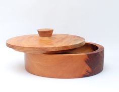 two wooden bowls with lids on white background