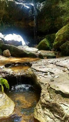 a small waterfall in the middle of some rocks