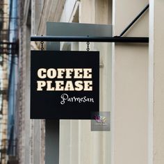 a black sign hanging from the side of a building that says coffee please on it