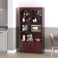 a kitchen area with a microwave, coffee maker and other items on a shelf next to a chair