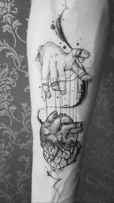 a person with a tattoo on their arm that has an animal in the cage and a dog