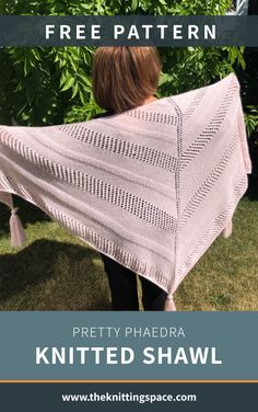 a woman holding up a pink shawl in front of some trees and bushes with text overlay that reads free pattern pretty phaedra knitted shawl