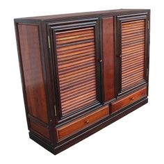 a large wooden cabinet with shutters on the doors