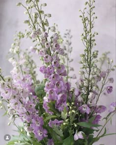 a vase filled with lots of purple flowers