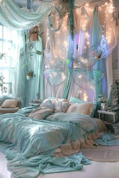 a bed room with a large bed covered in blue sheets and fairy lights hanging from the ceiling