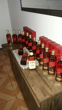 many bottles of liquor are lined up on a table