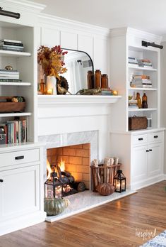 a living room filled with furniture and a fire place in the middle of a wooden floor