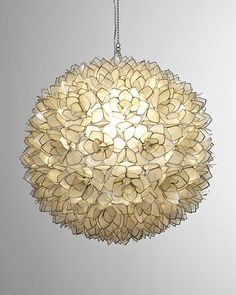 a chandelier hanging from the ceiling with many petals on it's head