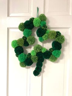 a green wreath hanging on the front door