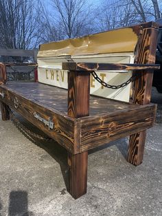 a wooden bench sitting on top of a cement ground