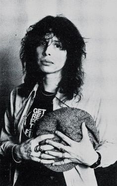 an old black and white photo of a person holding a stuffed animal in their hands