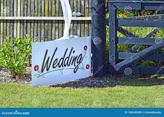 a wedding sign in front of a wooden fence