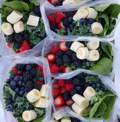 four plastic bags filled with fruit and veggies