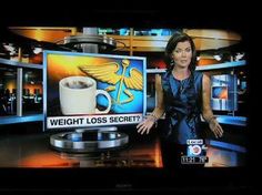 a news anchor is standing next to a coffee cup