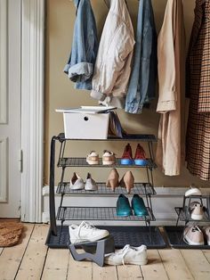 there are many pairs of shoes on the rack in this room, and one is empty