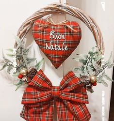 a wreath with a bow hanging on the wall next to a sign that says broon natale