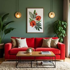 a living room with green walls and red couches in front of a painting on the wall