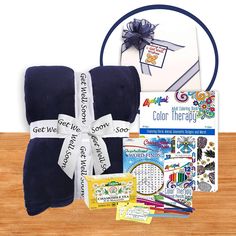 the blue gift box contains several items including a blanket, coloring book and stickers