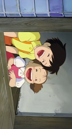 two young children standing next to each other in front of a window with their mouths open