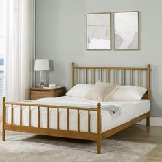 a bed sitting in a bedroom on top of a wooden floor next to a window