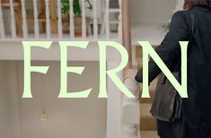 a woman walking up some stairs with the word fern in front of her