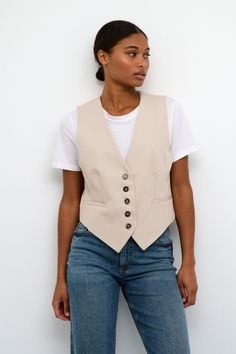 The SLEEVELESS BEIGE WAISTCOAT is a must-have for any wardrobe. Its shaped fit accentuates the waist while its button-down design adds a touch of sophistication. Made with high-quality materials, this waistcoat is both stylish and durable. Elevate your outfit with this sleek and timeless piece. Style: 10507907 Color: Beige Fabric: 77% Polyester (Recycled), 18% Viscose, 5% Elastane Also available in Black Button Down Vest Outfits For Women, Waistcoat Style, Vest Beige Outfit, Jeans Waistcoat, Waistcoat And Jeans Outfit, Beige Waistcoat Outfit Women, Beige Black Outfit, Outfits Beige, How To Style Waistcoat Women