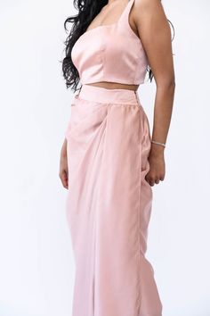 *Orders placed between April 4 - April 21 will be shipped starting April 24. Contact us here if you need your items sooner!* Experience the understated elegance of our Satin Drape Skirt. Crafted with a fitted waistband for a seamless silhouette fit and finished with a timeless drape, this piece is crafted from a luxuriously soft silk satin fabric, perfect for a flowy, feminine look. Features: Zipper and hook closure Fitted waistband 44" length across all sizes Included in purchase: Rose Gold Dra Satin Drape Skirt, Gold Drapes, Silk Satin Fabric, Wardrobe Update, April 4, April 21, Neck Chain, Understated Elegance, Feminine Look