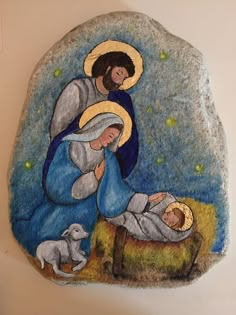 a painted rock depicting the birth of jesus