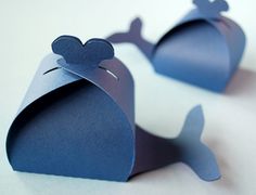 two pieces of paper are shaped to look like a whale