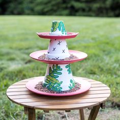 three tiered cake stand on top of a wooden table