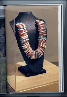 a display case with a necklace in it