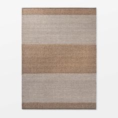 a brown and white rug with horizontal stripes on the bottom, in front of a white wall