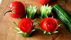 cucumbers and tomatoes are arranged on a cutting board