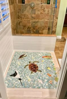 a bathroom with tile flooring that has sea animals on it