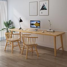 two chairs and a table with a computer on it in front of a window next to a potted plant