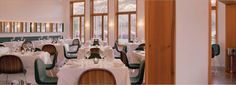 an empty restaurant with tables and chairs set up for formal dining in front of large windows