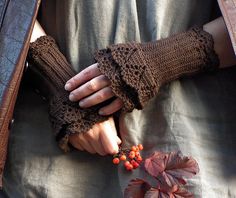 a person wearing gloves and holding berries in their hands