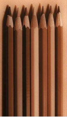 several brown pencils lined up next to each other