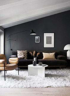 a living room with grey walls and white furnishing on the floor is shown