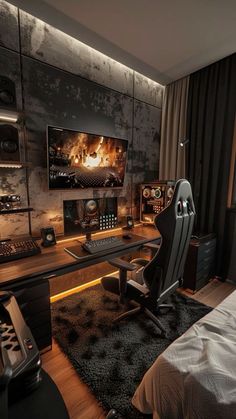 a bedroom with a bed, desk and computer monitor on the wall in front of it