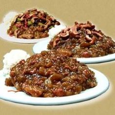 three plates filled with food on top of a brown tablecloth covered floor next to each other